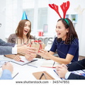 stock-photo-cheerful-business-people-giving-christmas-presents-during-meeting-345747851