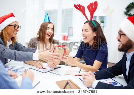 stock-photo-cheerful-business-people-giving-christmas-presents-during-meeting-345747851.jpg